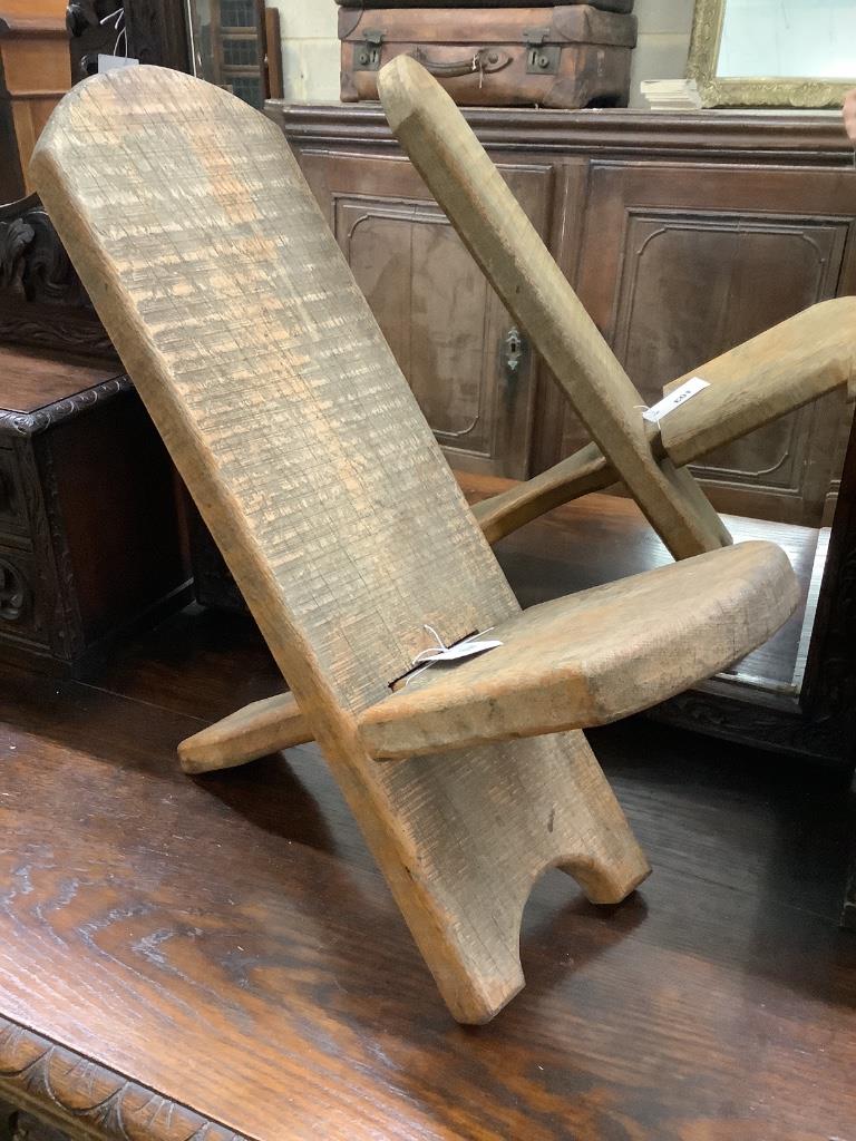 A primitive pine stool, width 44cm height 55cm